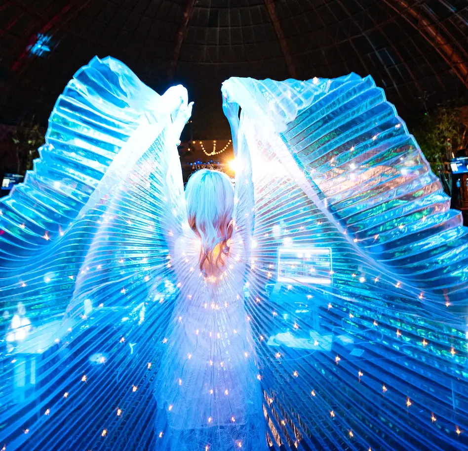 DJ Shelly performing Glow Show with glow wings at Harrah’s Pool After Dark in Atlantic City