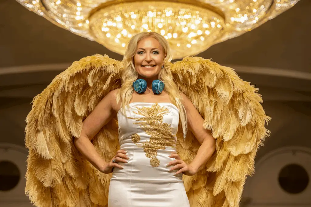 DeeJay Shelly wearing her gold wings during a luxury event at the Ritz-Carlton Philadelphia – female DJ and entertainer